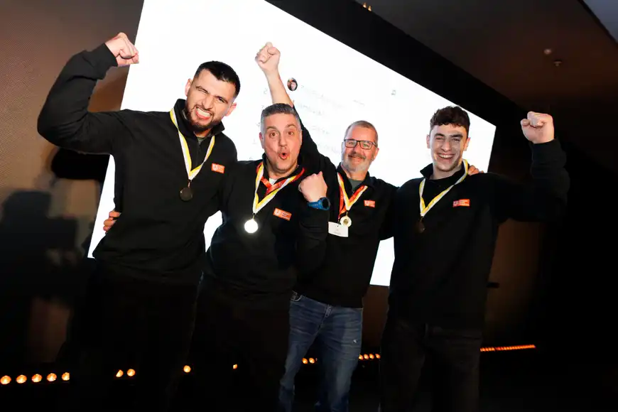 Business team celebrating success after completing an indoor group challenge