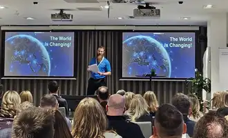 facilitator presenting to a group about to take on the experiential learning team training event detour in ireland