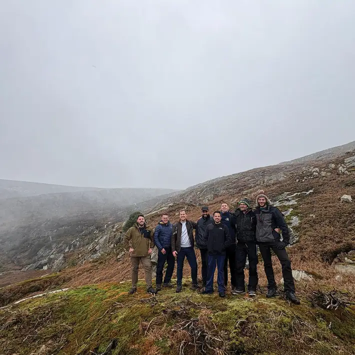 Senior leadership team hiking in Wicklow Mountains during outdoor team building experience