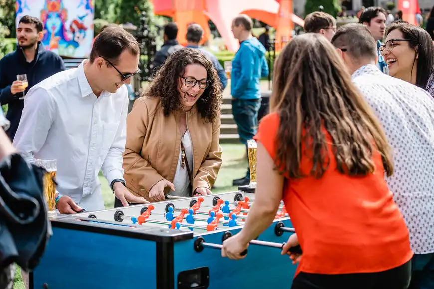 Staff playing foosball during an outdoor company team building event in Dublin