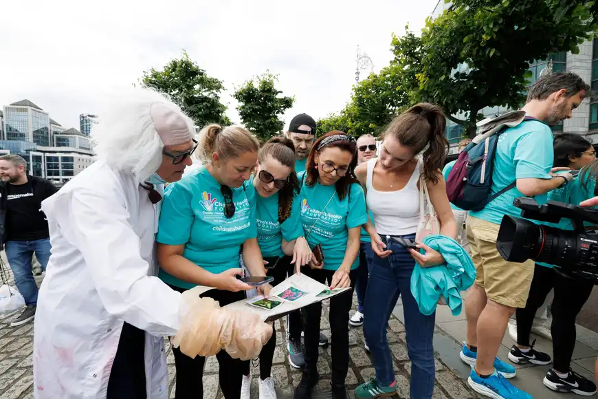 Office team solving puzzles with a facilitator during a problem solving team building challenge in Ireland