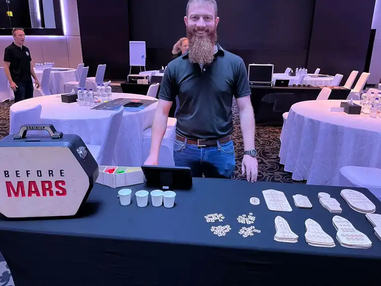 Niall standing behind a before mars desk with the branding an all the props needed to host the event | Team Training Galway