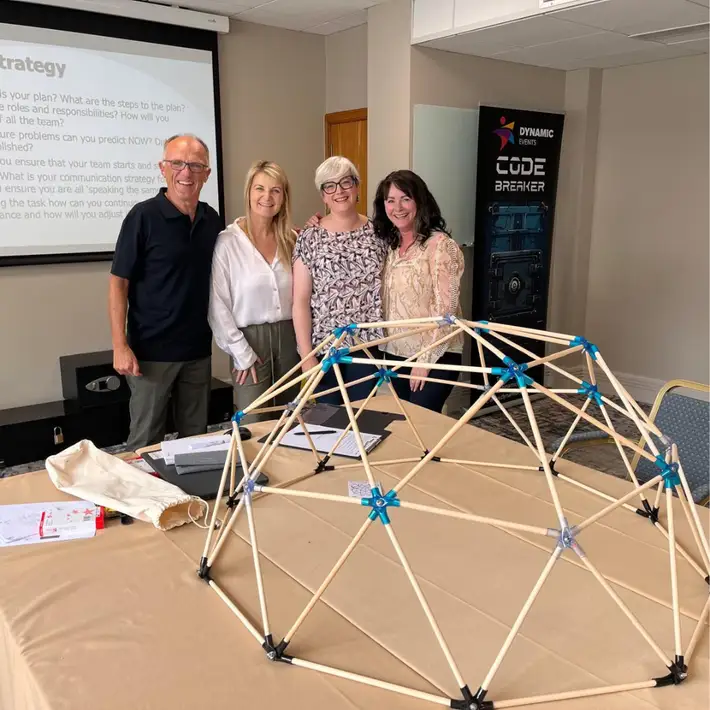 Corporate group standing around dome works