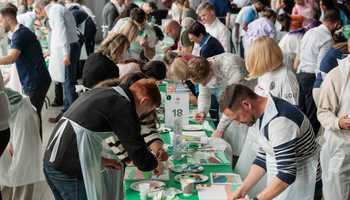 Colleagues from different departments taking part in a team building Big Picture challenge in an indoor setting