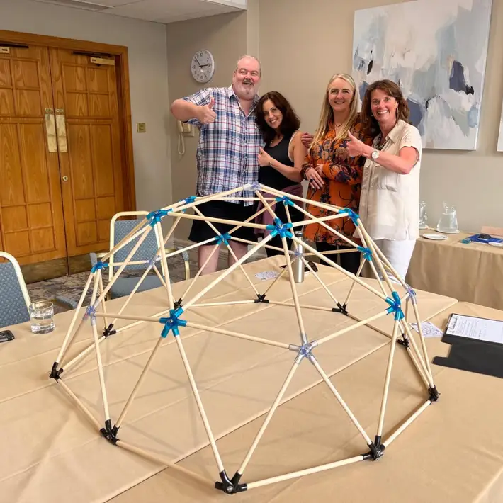 Group standing around dome works