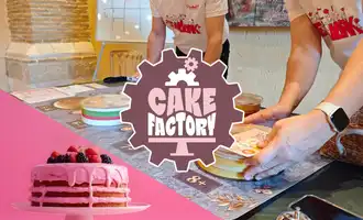 The Cake factory Team Building Activity with people building fake cakes on a table