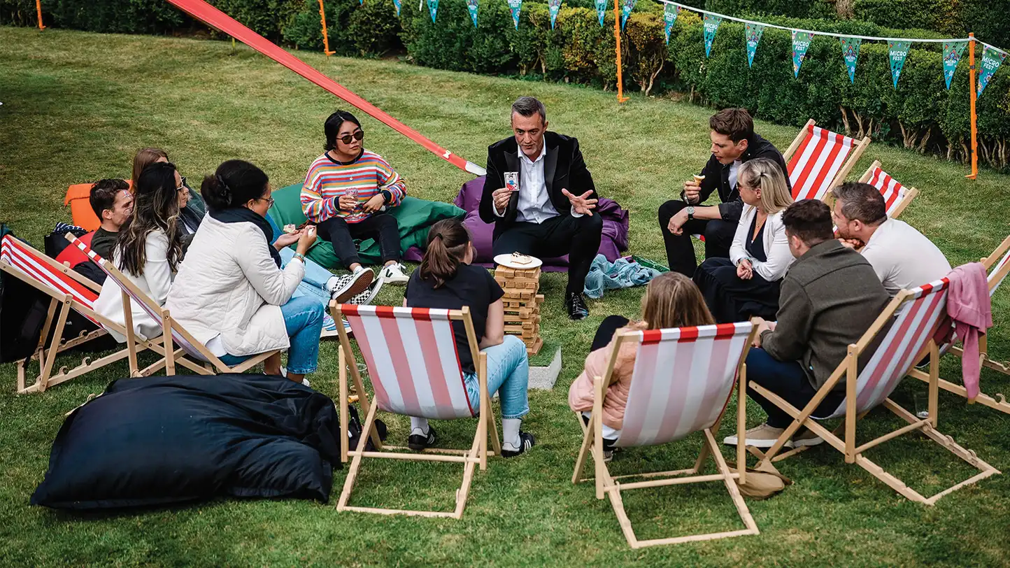 Corporate team building magic workshop in Ireland with magician Joe Daly engaging participants at a company event
