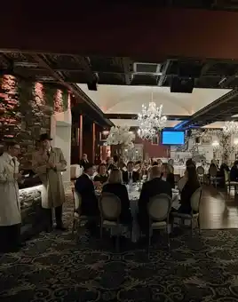 People looking at the actors who are acting out the murder mystery