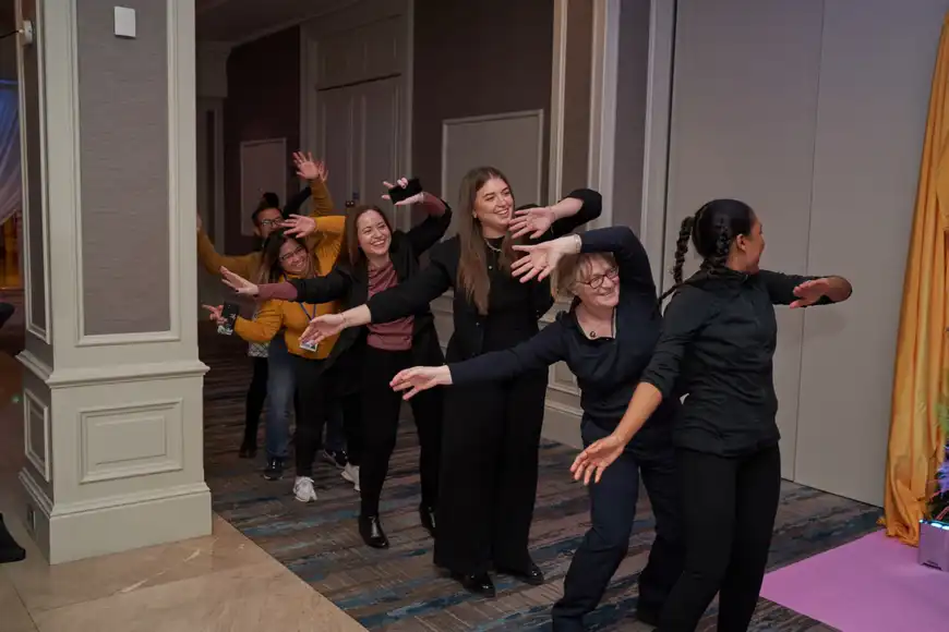 Corporate group engaging in interactive leadership team building exercise