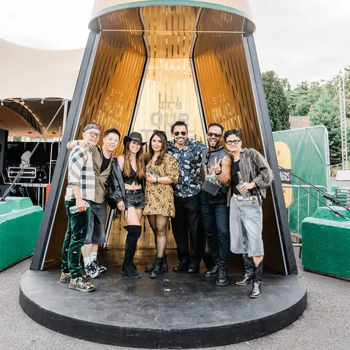 Guests posing in the bulmers bottle backdrop 