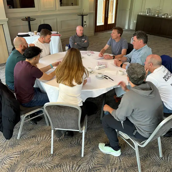 MBA students in Ireland taking part in a facilitated group discussion during a Team Development Day, reflecting on leadership, collaboration and teamwork.