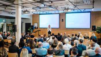 Corporate away day event with keynote speaker presenting to employees in a modern Dublin conference venue