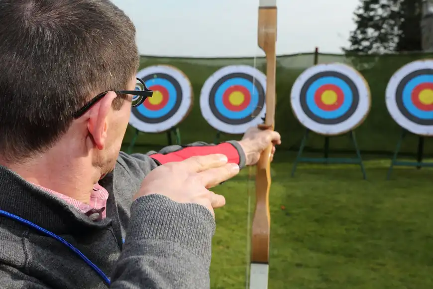 Corporate team building in Ireland with archery challenge activity, outdoor event for employee engagement and team bonding.