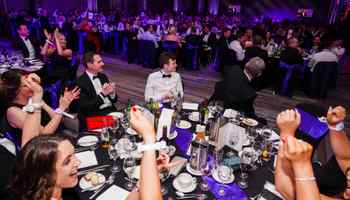 Corporate gala dinner and awards night in Dublin with 300 guests celebrating, cheering, and enjoying a formal black tie evening