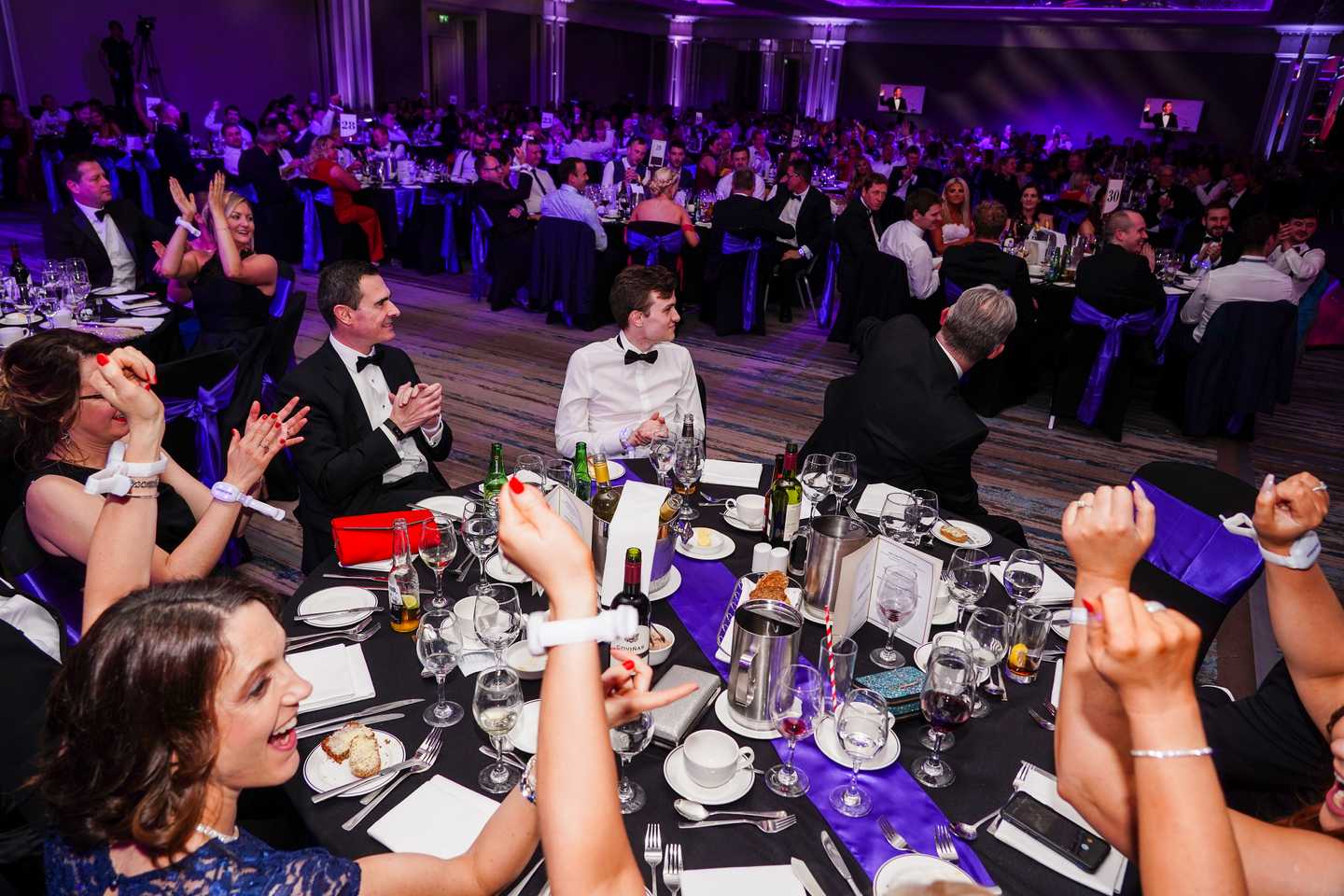 Corporate gala dinner and awards night in Dublin with 300 guests celebrating, cheering, and enjoying a formal black tie evening