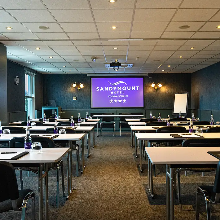 Theatre-style meeting room at The Sandymount Hotel, fully equipped with a projector, AV system, and delegate essentials for corporate events.