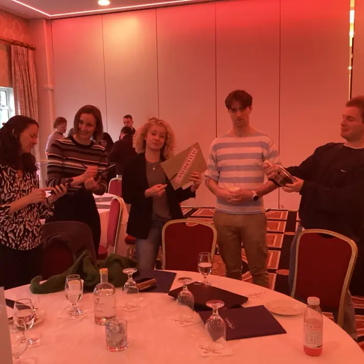 Team members collaborating on clues during the Murder Mystery Team Building game.