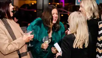 Guests laughing and chatting at a corporate networking event at Clayton Hotel Cardiff Lane in Dublin.