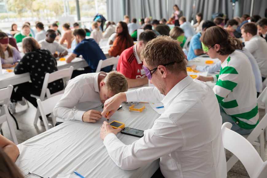 Team assembling solar lights while blindfolded during SolarBuddy CSR team building activity