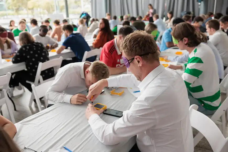 Team assembling solar lights while blindfolded during SolarBuddy CSR team building activity