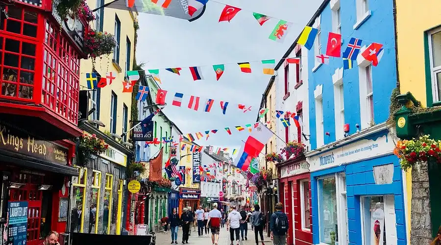 Quay Street, Galway City decorated with flags and colourful buildings | Team Traiing Galway