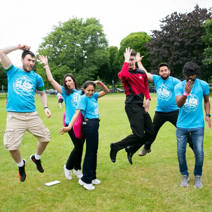 Corporate group celebrating together at an outdoor team building event in Dublin, part of Dynamic Events’ Space Survival digital treasure hunt experience.