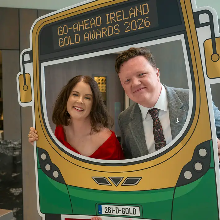 Guests posing with the branded tram photo prop at the Go-Ahead Ireland Gold Awards drinks reception.