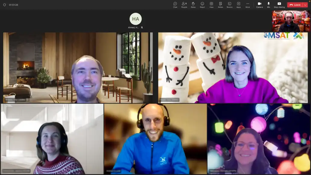 Corporate team enjoying a Virtual Christmas Team Building event on Zoom with festive backgrounds, holiday outfits and interactive online activities