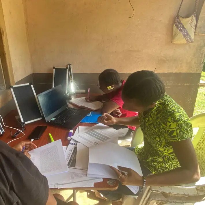 2 kids studying with their solar lights