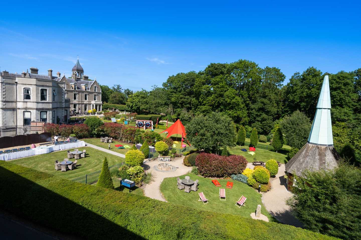 Beautiful landscaped gardens set up with outdoor team building activities at Killashee Hotel on a sunny summer day