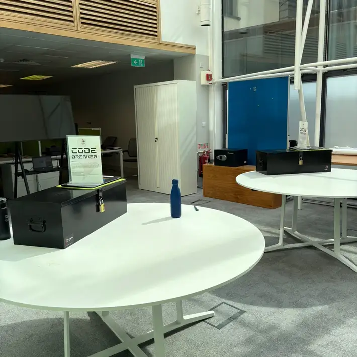 set up for code breakers on two sepeprate table and the final lockbox on a desk