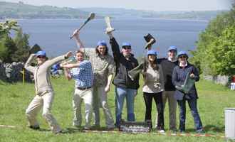 Corporate team outdoors celebrating after Irish-themed team building games