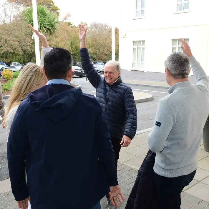 Colleagues celebrating with high fives outside the Galway Bay Hotel after completing their treasure hunt challenge