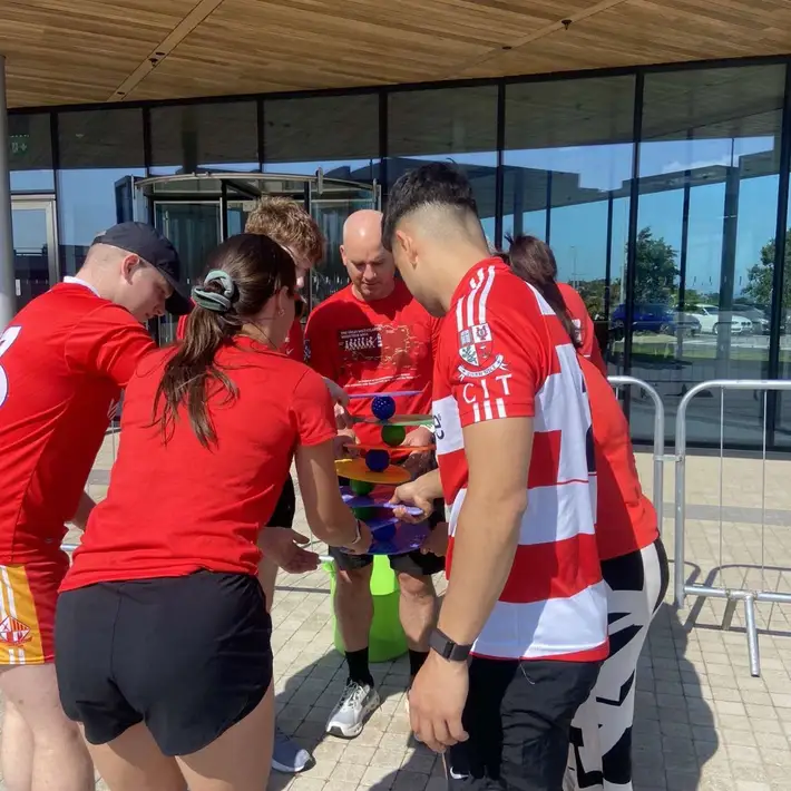 Apple team collaborating  during bat and ball 