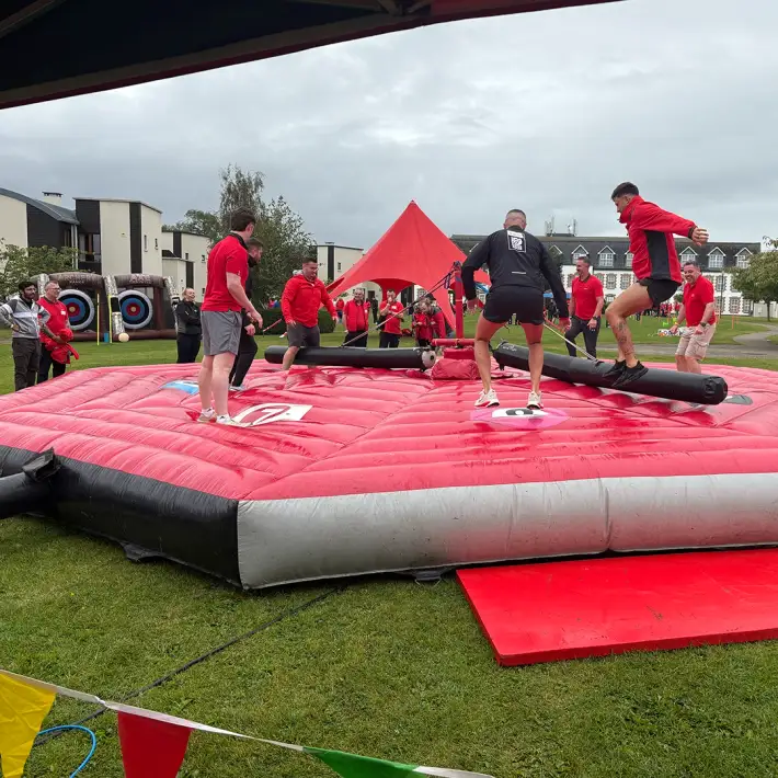 Hilti staff competing on inflatable wipeout style challenge during Team Olympics summer party event