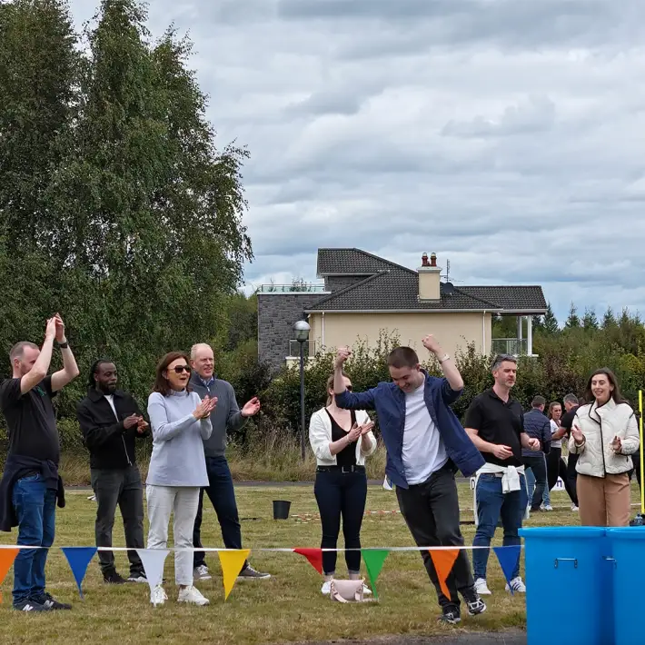 Moore Ireland team celebrating during outdoor team building challenge with Dynamic Events Ireland at Heritage Hotel Killenard