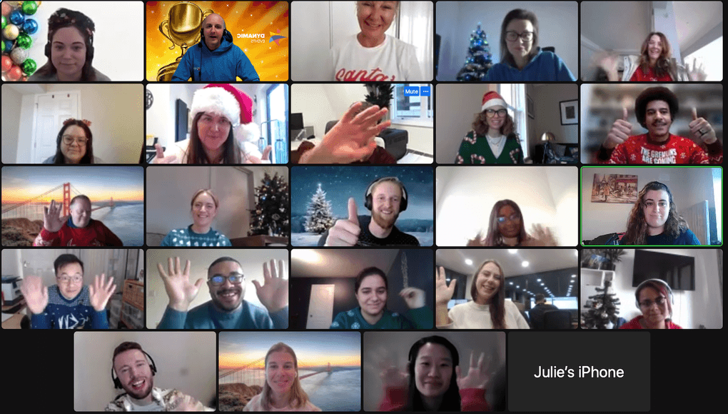 Corporate virtual Christmas party with employees in festive jumpers and Santa hats smiling and waving on Zoom – team building for remote teams Ireland