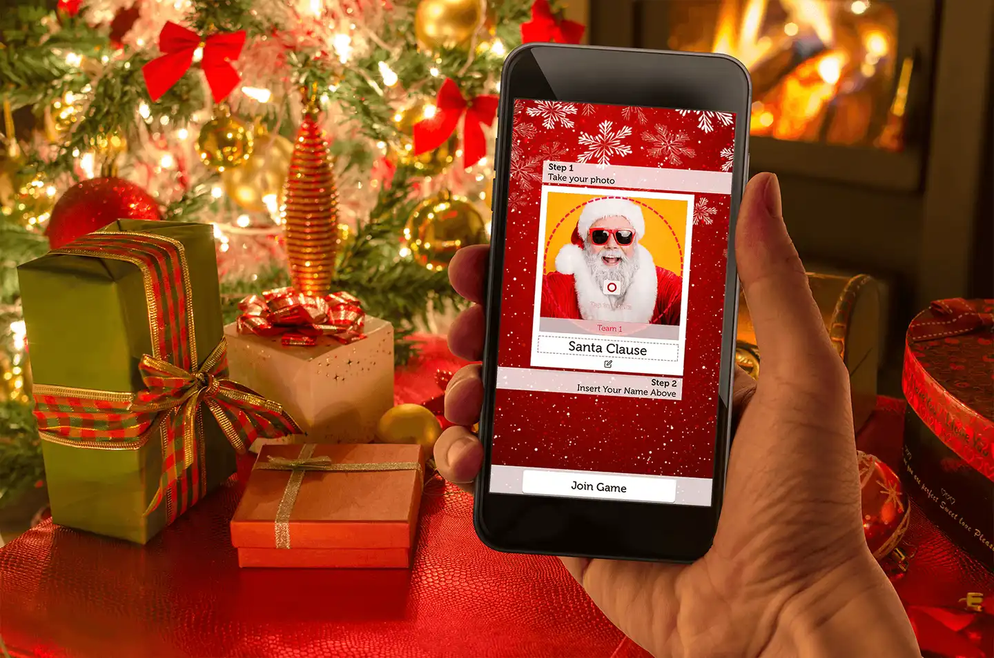 christmas crackers game on phone with christmas presents and tree in the background