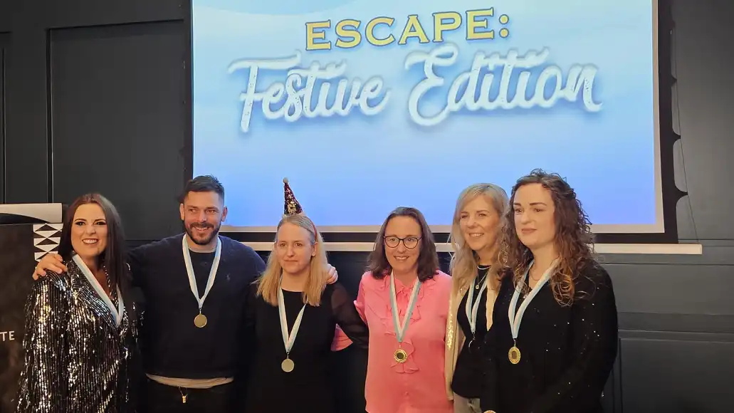 Winning corporate team celebrating after completing Escape: Festive Edition Christmas team building challenge in Ireland.