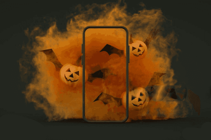 Three animated pumpkins flying around a phone