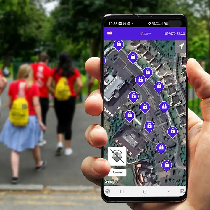 Remote team building treasure hunt map on smartphone with team walking in park ireland