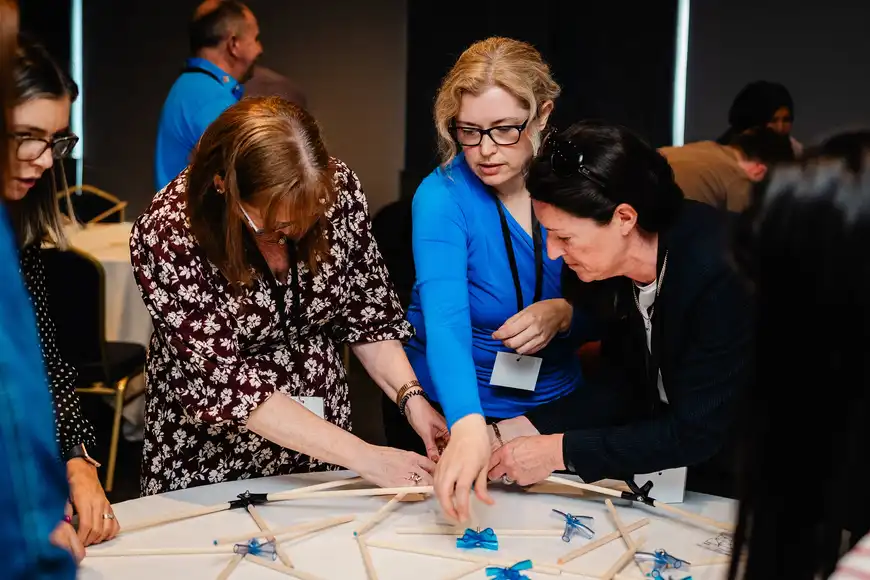 Senior managers collaborating on a hands-on team building activity during an executive away day