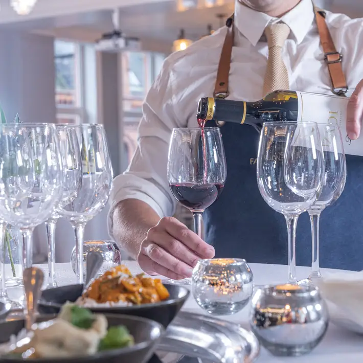 Plan your corporate team building session at Fallon & Byrne pouring wine at an event | Dynamic Events