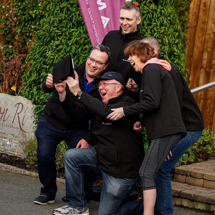 Corporate team taking a group selfie during a Digital Treasure Hunt in Ireland.