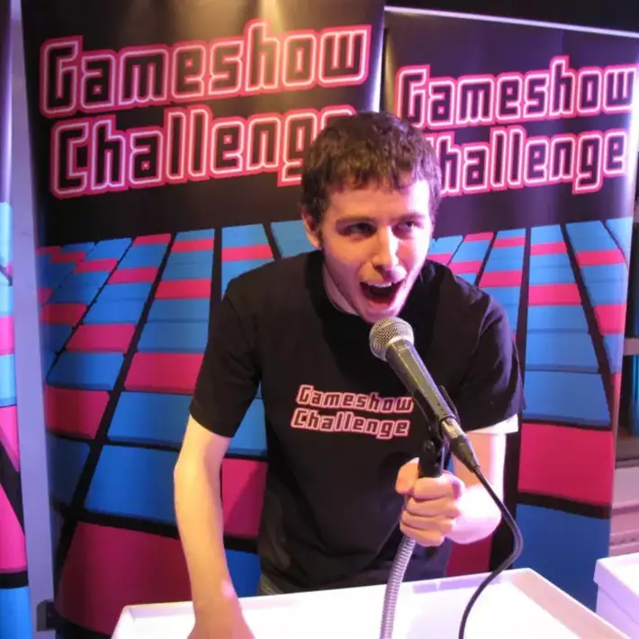 Professional host leading the Gameshow Challenge for a corporate group