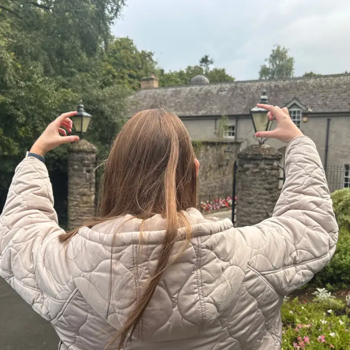 ABP Food Group graduate creating a forced perspective photo during a digital treasure hunt challenge at their location in Ireland.
