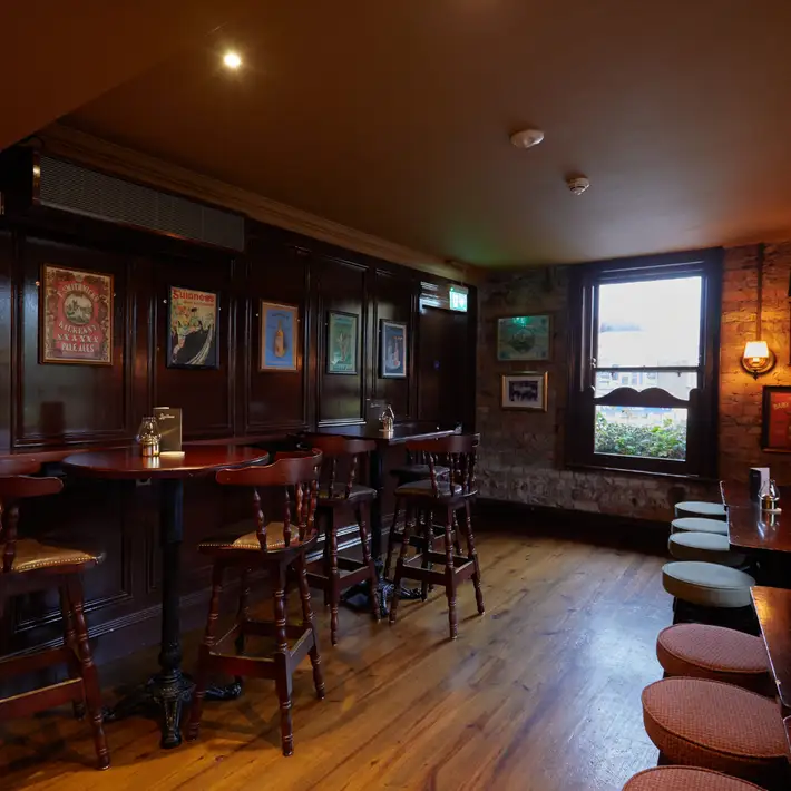 Tall bar tables in the long part of the bar