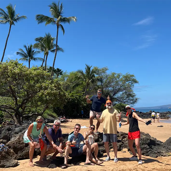 Corporate incentive group participating in treasure hunt team building on Hawaii beach