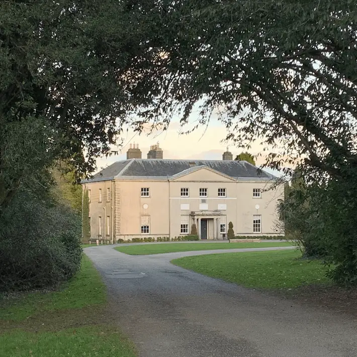 Exterior shot of Avondale House surrounded by lush forest grounds