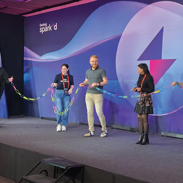 Corporate team training session on stage with interactive group challenge at Productboard event in Mexico City